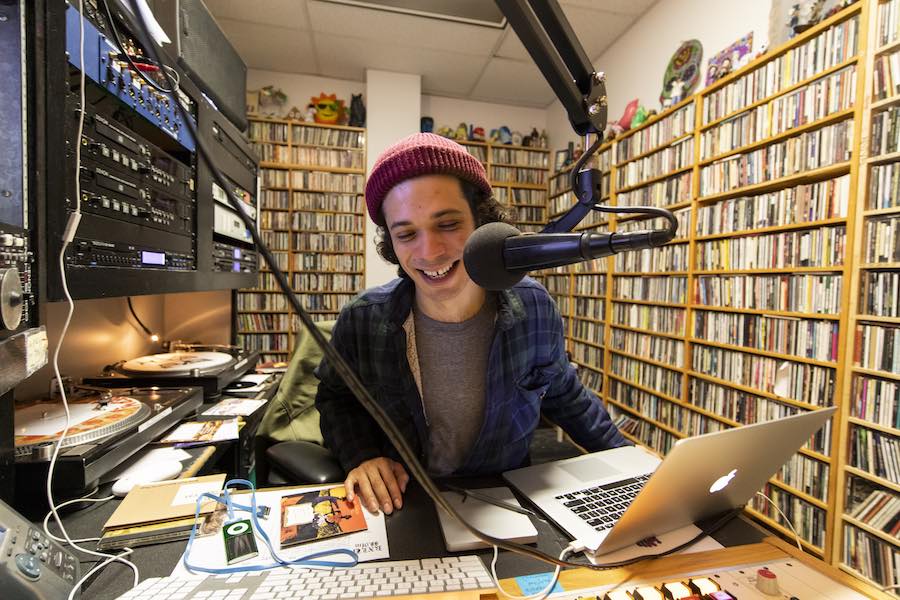 student DJ broadcasting on KXLU studio