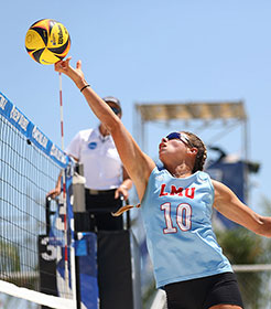 volleyball player hitting ball over the net