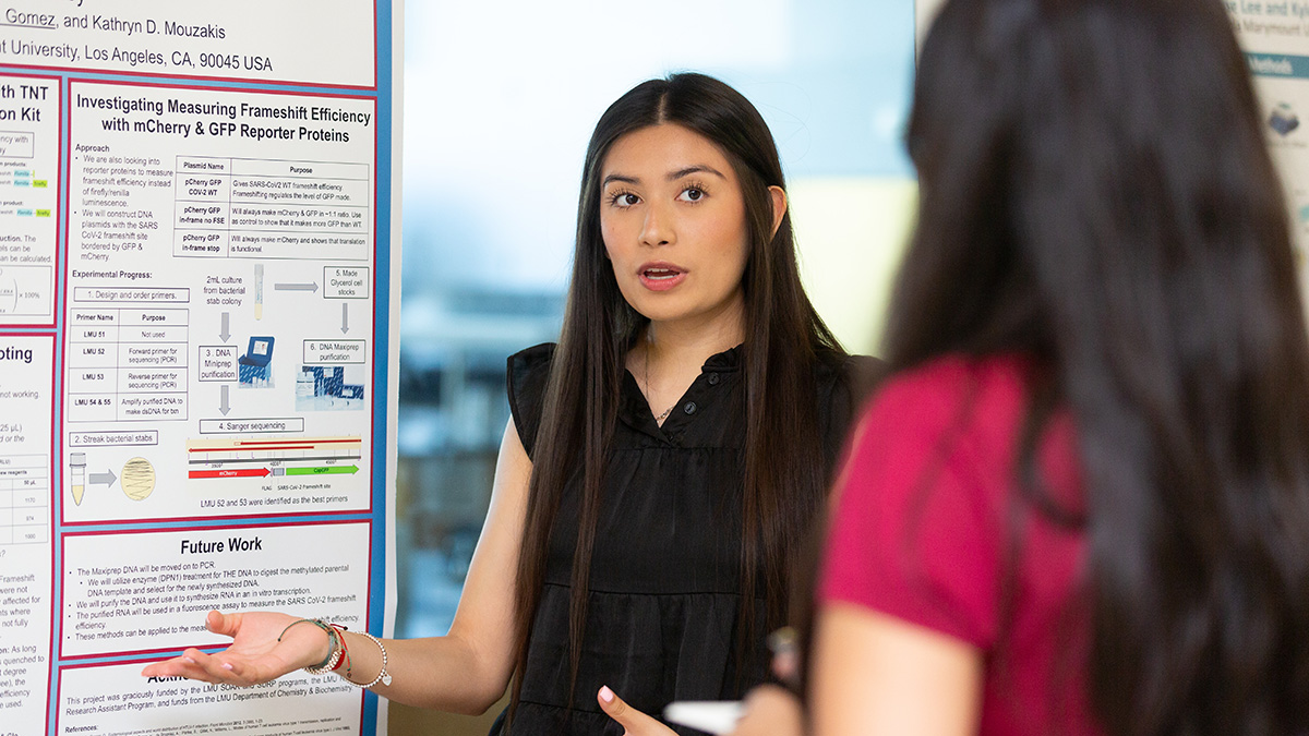 students sharing their research posters