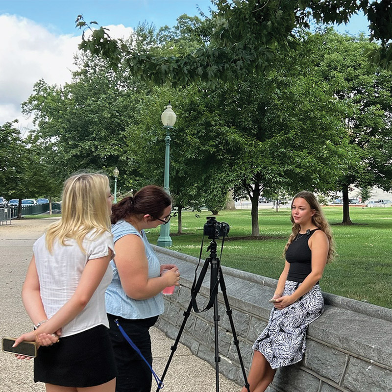 Three LMU Student Journalists recording in the field