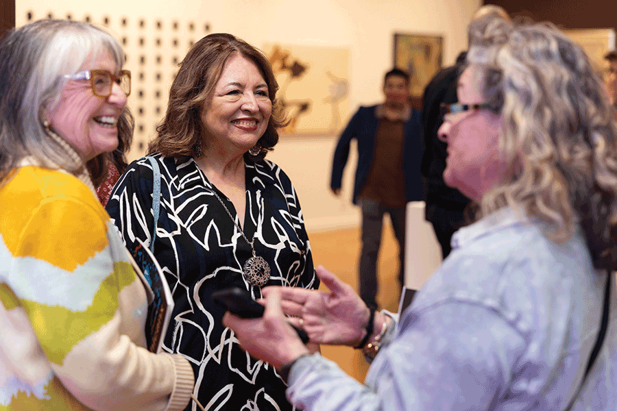 Mary Salinas Durón ’75, center, celebrates the opening of exhibition