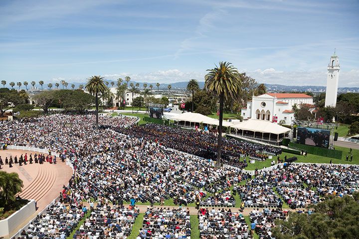 Aerial view of commencement as the graduates file into Sunken Garden