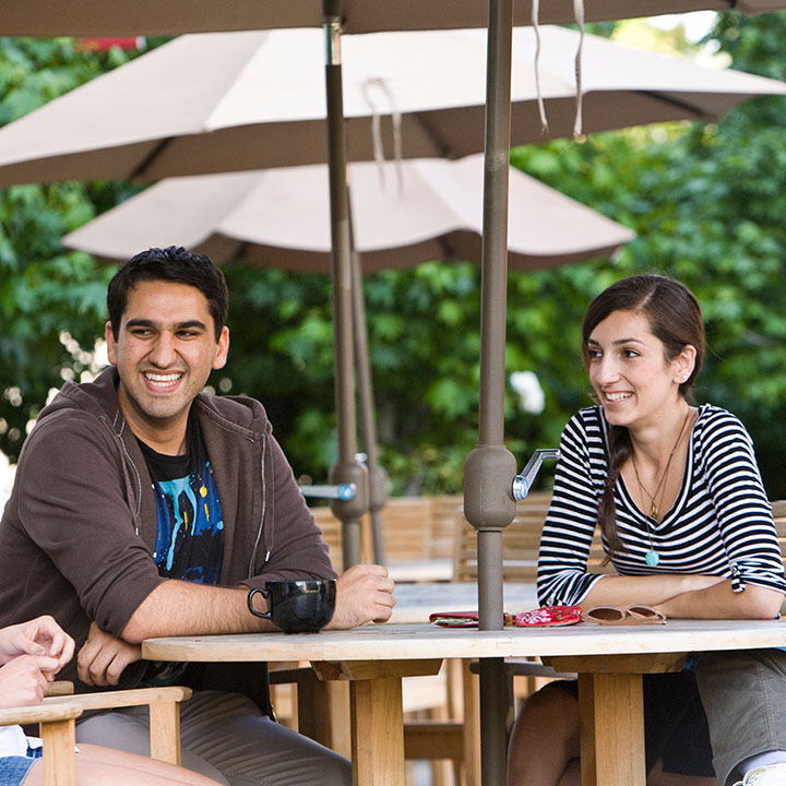 Students sitting at a table and laughing